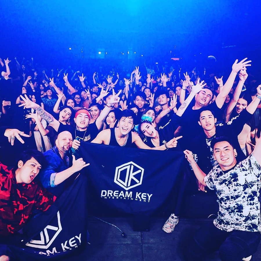 Packed Dreamkey Entertainment event crowd with the Dreamkey flag